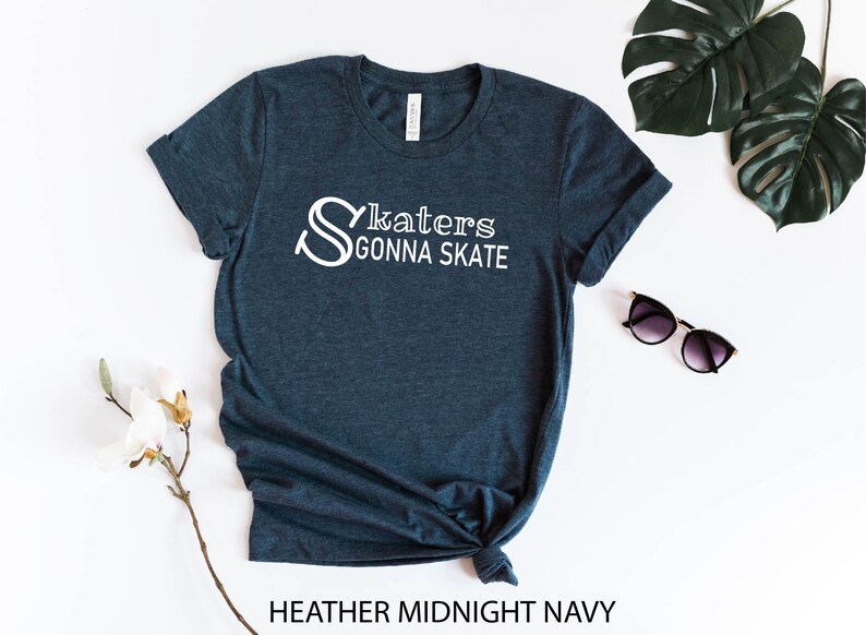 May include: A dark blue t-shirt with the text "Skaters Gonna Skate" in white lettering. The shirt is made of a soft, comfortable material and is perfect for everyday wear.