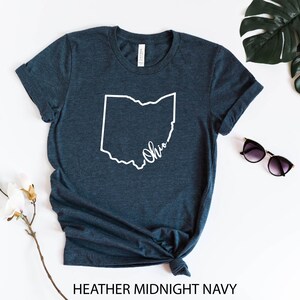 May include: A heather midnight navy t-shirt with a white outline of the state of Ohio and the word "Ohio" written inside the outline.