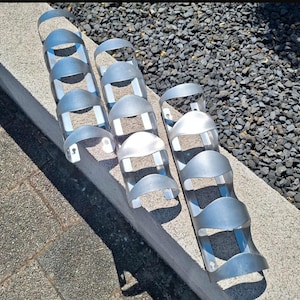 May include: A white ceramic mug with a black handle and the text "But First, Coffee" in a black, bold font. The mug is on a white surface. The mug is approximately 4 inches tall.