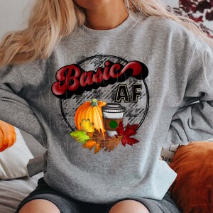 May include: Gray sweatshirt with a graphic design of a pumpkin, a cup of coffee, and the text "Basic AF" in a red and black circle.