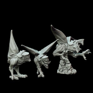 May include: Three gray, detailed, miniature gargoyle figurines. The gargoyles are in various poses, with wings spread and mouths open. The figurines are made of a smooth, matte material.