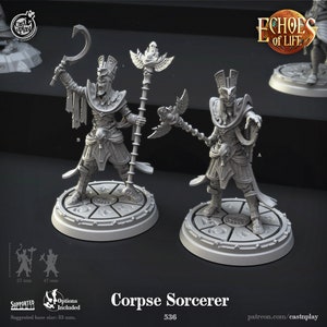 May include: Two gray 3D printed miniature figures of a corpse sorcerer, each holding a staff and a curved blade. The figures are standing on circular bases with intricate designs. The text "Corpse Sorcerer 536" is printed below the figures.