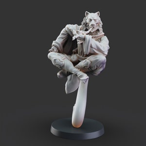 May include: A white painted figurine of a wolf-like creature sitting cross-legged with a pipe in its mouth. The figurine is perched on a curved base.