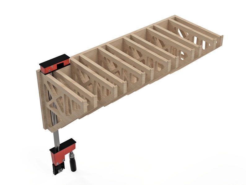 May include: A light-colored wooden shelf with a geometric design, held together by red and black clamps. The shelf has multiple compartments and is likely for storage or display. The clamps are positioned at the end of the shelf.