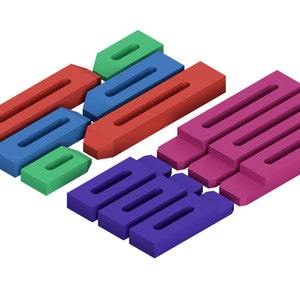 May include: An assortment of colorful, geometric shapes in red, blue, green, purple, and pink. The shapes are rectangular with a long, narrow cutout. The arrangement suggests a puzzle or building blocks.