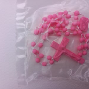 Pink plastic rosary.