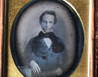 6 th plate daguerreotype  of  a man, a head and shoulders shot. writing inside  1/2 case says Grandpa Stillman. Antique photo. Hazy on vest.