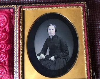 6 th plate daguerreotype  in one complete  Dark Pink plush. Woman in a dark dress.Tinted face.