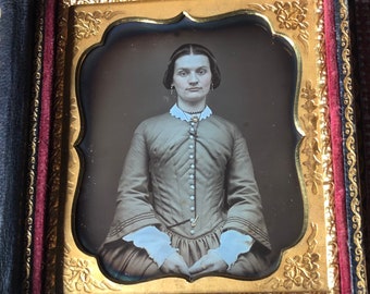 A sixth plate  daguerreotype with whole case and intact spine. A mother of pearl case. Lovely portrait of a woman. Fashion.