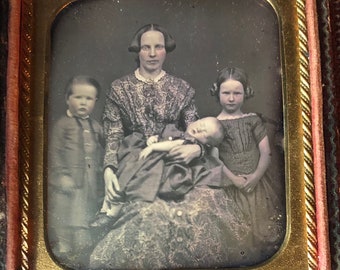 6 th plate daguerreotype of a pretty woman, and her three  beautiful children.  Mother is holding a sleeping child. Antique photo.