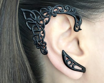 May include: A pair of black ear cuffs with intricate, delicate designs. The cuffs are made of a lightweight metal and are designed to fit comfortably on the ear.