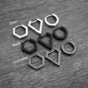 May include: An assortment of geometric hoop earrings in silver, black, and gunmetal finishes. The earrings feature various shapes, including hexagons, triangles, and circles. The word "Silver", "Black", and "Gunmetal" are written on the image.