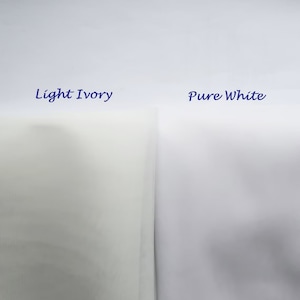 May include: Two fabric swatches, one labeled "Light Ivory" and the other "Pure White". The ivory swatch is a pale cream color, while the white swatch is a bright white.