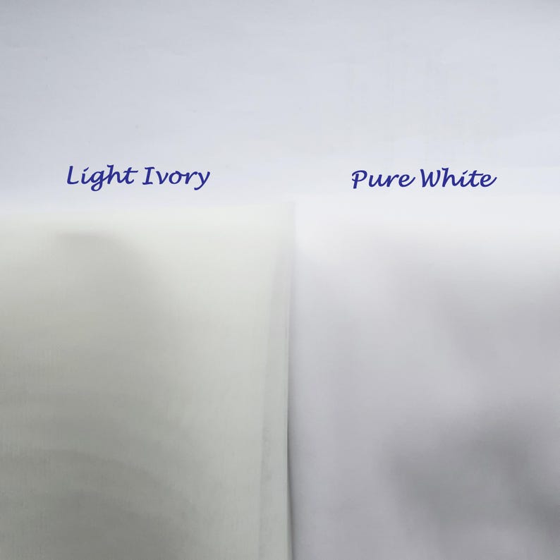 May include: Two fabric swatches, one labeled "Light Ivory" and the other "Pure White". The ivory swatch is a pale yellow color, while the white swatch is a bright white.