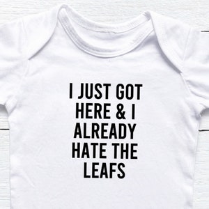 I Just Got Here And I Already Hate The Leafs Baby Onesie®, Hockey Baby Onesie®, Hockey Fan Baby Gift, Flyers Habs Flames Oilers Jets Bruins