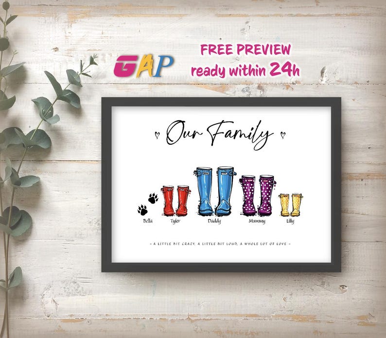 May include: A framed print titled Our Family featuring illustrations of five pairs of rain boots in red, blue, purple, and yellow, with paw prints for Bella, names for Tyler, Daddy, Mommy, and Lilly, and the text A LITTLE BIT CRAZY, A LITTLE BIT LOUD, A WHOLE LOT OF LOVE.