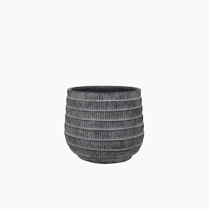 May include: A dark gray, round, textured planter with a ribbed design. The planter is made of concrete and has a slightly rounded bottom.