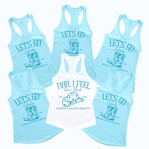Puede incluir: Seis camisetas sin mangas de color azul claro con un tema de despedida de soltera. Cuatro de las camisetas sin mangas tienen el texto "Let's Go Girls" con un par de botas de vaquero. Una camiseta sin mangas tiene el texto "Man, I Feel Like a Bride" con un sombrero de vaquero. Todas las camisetas sin mangas tienen el texto "Sophia's Bachelorette" impreso en ellas.