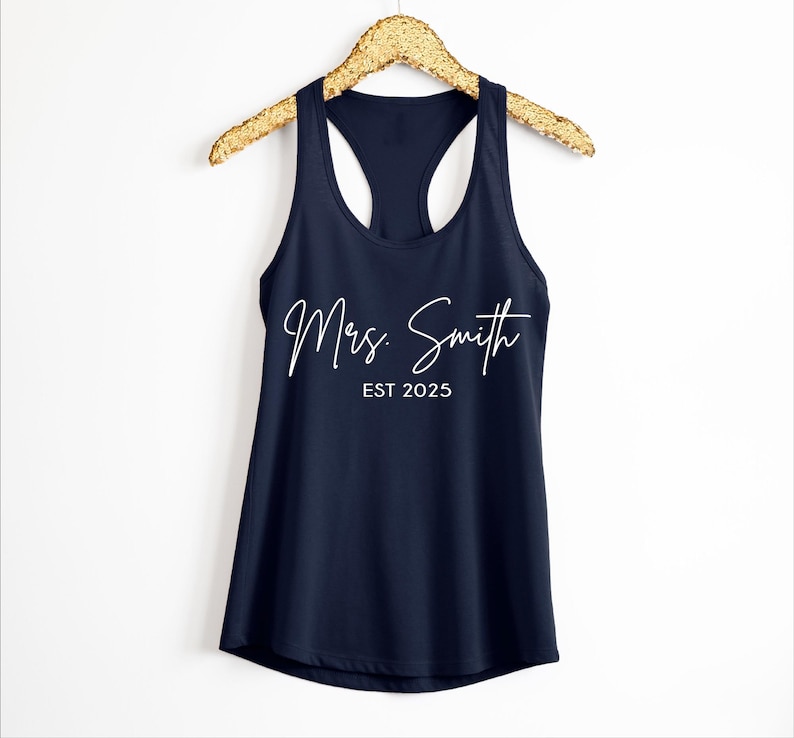 Pu&ograve; includere: Un top a canotta blu navy con il testo "Mrs. Smith EST 2025" in bianco.