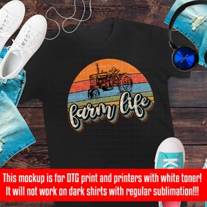 May include: A black t-shirt with a vintage-style graphic of a red tractor driving through a sunset with the text "farm life" in a retro font.