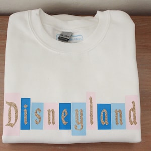 Classic Disneyland Marquee Sign Sweatshirt w/ Gold | Sleeping Beauty Castle Colors | Disney Jacket | Disney Outfit | Cute Disney Crewneck