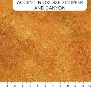 May include: Close-up of a fabric with a textured, mottled appearance in shades of orange, brown, and yellow. The fabric has a scale at the bottom with measurements in inches. The text "ACCENT IN OXIDIZED COPPER AND CANYON" is at the top.