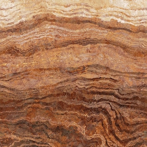 May include: A close-up of a brown and beige stone with a wavy, layered pattern. The stone has a natural, rustic look.