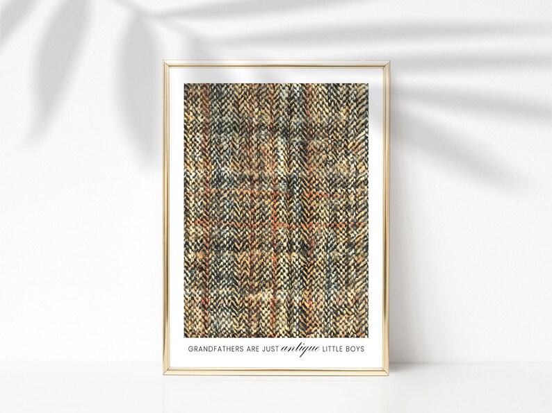 May include: A framed print with a textured pattern in shades of brown, black, and beige. The text "Grandfathers are just antique little boys" is printed below the pattern.