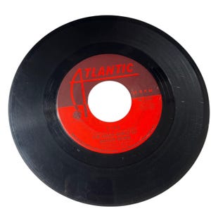 May include: A black 45 RPM vinyl record with a red and dark brown Atlantic label. The label features the text ATLANTIC, 45 R.P.M., 45-2556, FIRE, and THE CRAZY WORLD OF ARTHUR BROWN. The record has a circular center hole and a smooth, glossy surface.