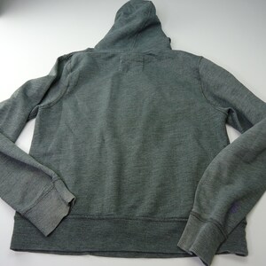 May include: A dark green hooded sweatshirt with a zipper closure. The sweatshirt has a ribbed hem and cuffs.