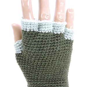 May include: Olive green fingerless gloves with a light grey crocheted trim. The gloves are made of a soft, textured yarn.