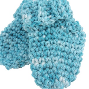 May include: A pair of blue and white crocheted baby booties. The booties are made with a soft yarn and have a simple design.
