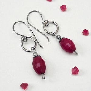 May include: A set of three ceramic mugs with a speckled, matte finish. The mugs are in shades of cream, light gray, and dark gray. Each mug has a simple, minimalist design, perfect for coffee or tea.