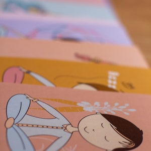 May include: A stack of cards with illustrations of a person meditating in different poses. The top card features a person in a blue shirt meditating with a pink background and a floral design.
