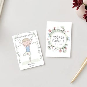 May include: Two cards with a white background and green and pink floral designs. The card on the left has a cartoon illustration of a person doing a yoga pose with the text 