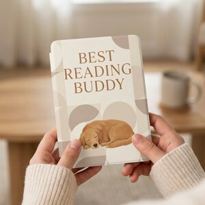 May include: A beige e-reader case with the text "BEST READING BUDDY" and a sleeping golden retriever illustration. The case has a geometric pattern in shades of beige and brown.