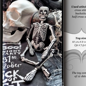 May include: A black and white cross-stitch skeleton toy with a skull and bones design. The toy is 31 inches by 7.5 inches and is made of 12 pieces. The toy is on a black background with a skull and the text "300! Might Party 31st October Trick or Treat".