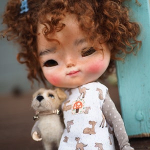 a close up of a doll with a dog
