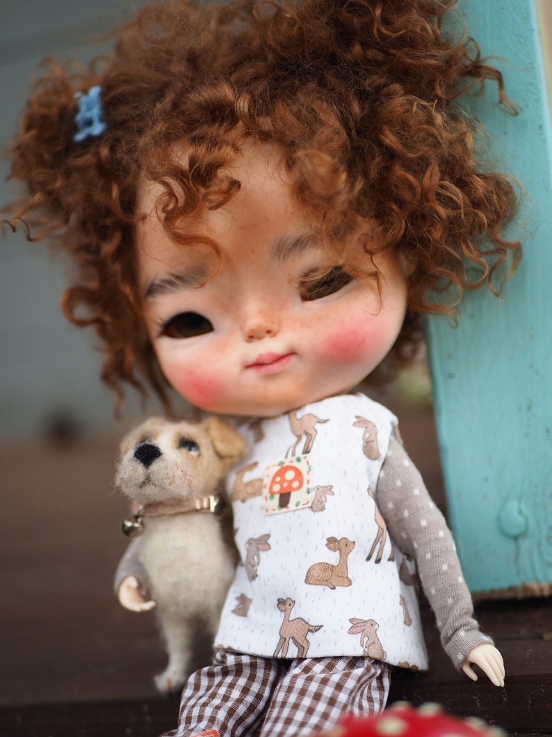 a close up of a doll with a dog