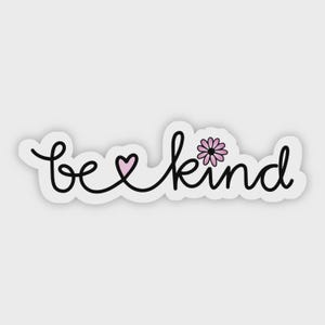 May include: A white sticker with the words "be kind" in a whimsical, handwritten font. The word "be" is connected to "kind" with a black line that forms a pink heart and a pink flower.