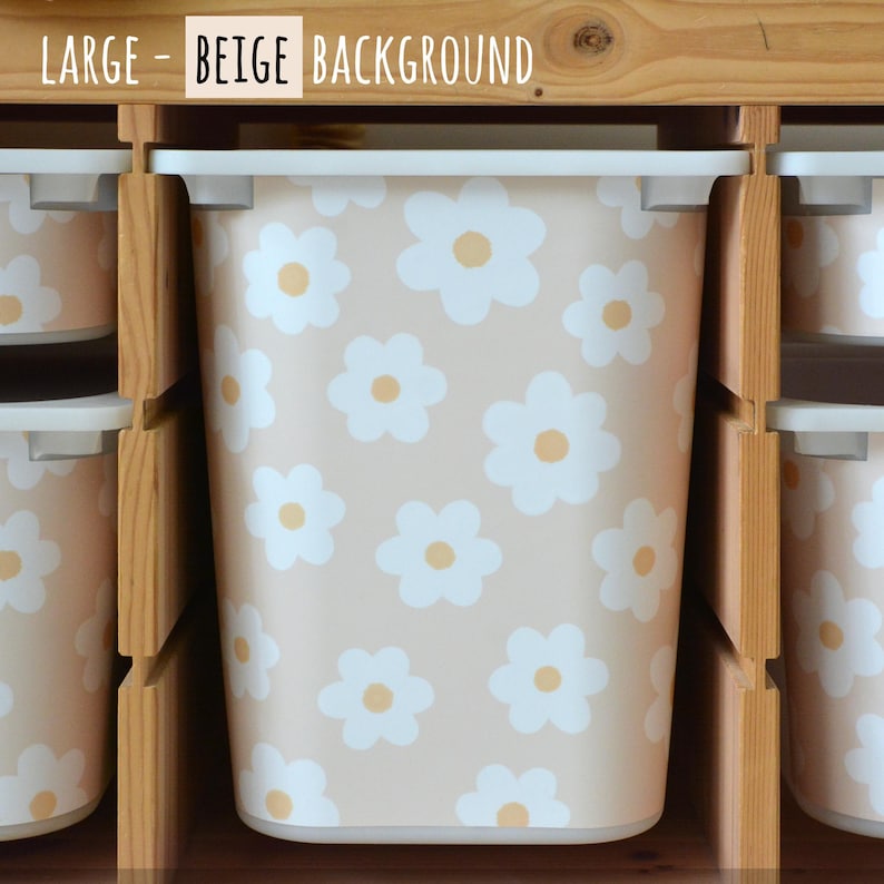 May include: A beige storage bin with a white daisy pattern and a yellow center. The bin is part of a set of storage containers. The text "LARGE - BEIGE BACKGROUND" is visible at the top of the image.