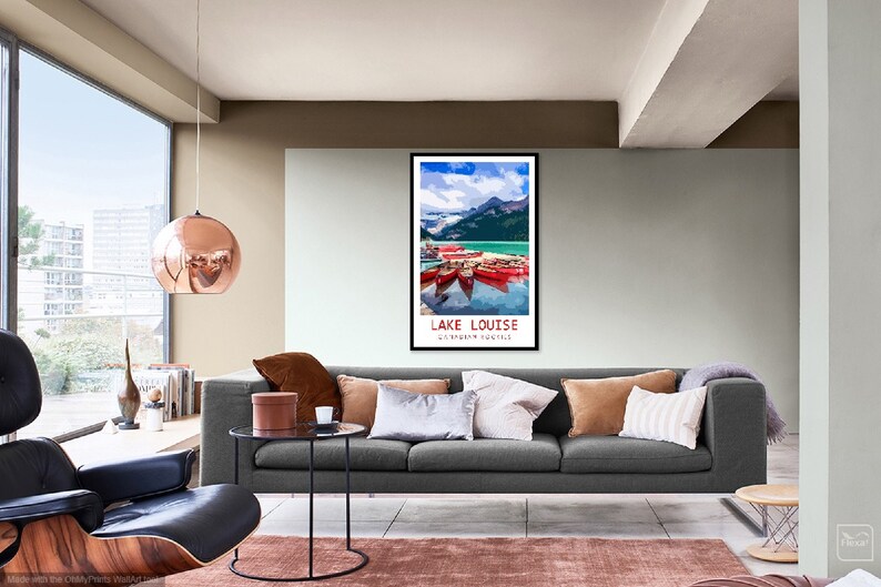 May include: A vintage travel poster featuring a scenic view of Lake Louise in Banff National Park, Canada. The poster depicts a turquoise lake with snow-capped mountains in the background and red canoes on the water. The text "LAKE LOUISE" and "BANFF NATIONAL PARK" is printed in white on a black background.