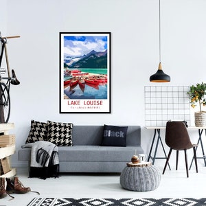 May include: A vintage travel poster featuring a scenic view of Lake Louise in the Canadian Rockies. The poster depicts a turquoise lake with snow-capped mountains in the background and red canoes docked at the shore.