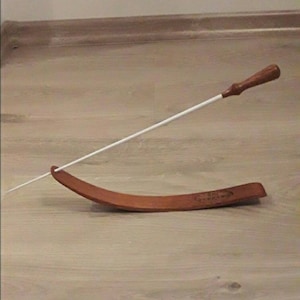 Conductor Baton on podium. Engraving of your text