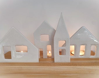 White ceramic village on wooden board
