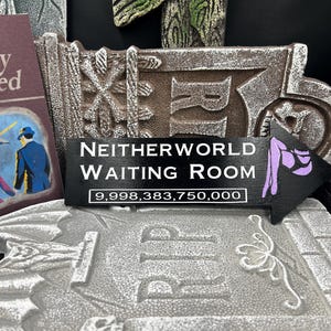 May include: A decorative sign with the text "NEITHERWORLD WAITING ROOM" and an arrow pointing right. The sign is black with white lettering and a purple graphic. The number "9,998,383,750,000" is below the text.
