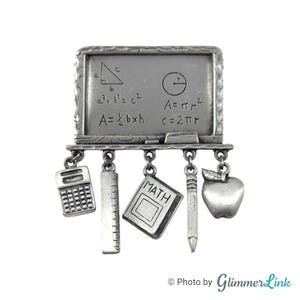 May include: A silver charm bracelet with a chalkboard charm featuring math equations, a calculator, ruler, book, pencil, and apple charms.