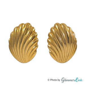 May include: A set of three ceramic mugs with a speckled, matte finish in cream, light grey, and dark grey. Each mug has a simple, minimalist design and a rounded handle.