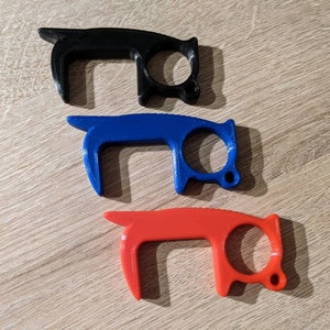 May include: Three door openers in different colours: black, blue, and red. Each opener has a loop handle and a small hook on the end.