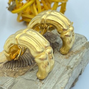 80s Givenchy bamboo clip on earrings in a matte gold tone finish